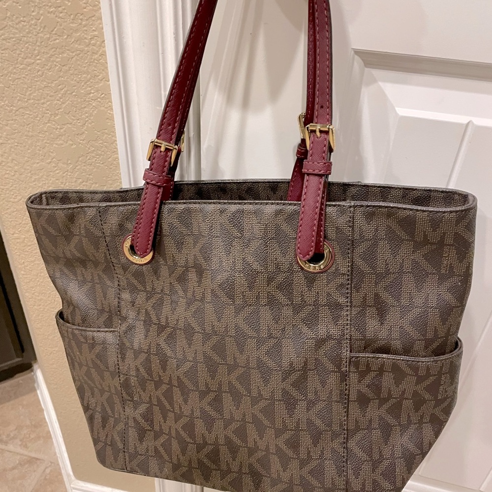 Michael Kors Tote with burgundy straps. Excellent condition.